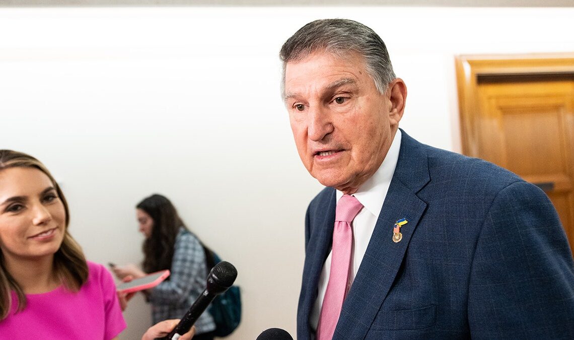 Joe Manchin talks to reporters