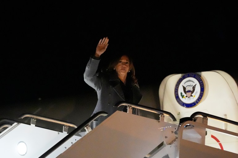 Kamala Harris waves as she boards Air Force Two