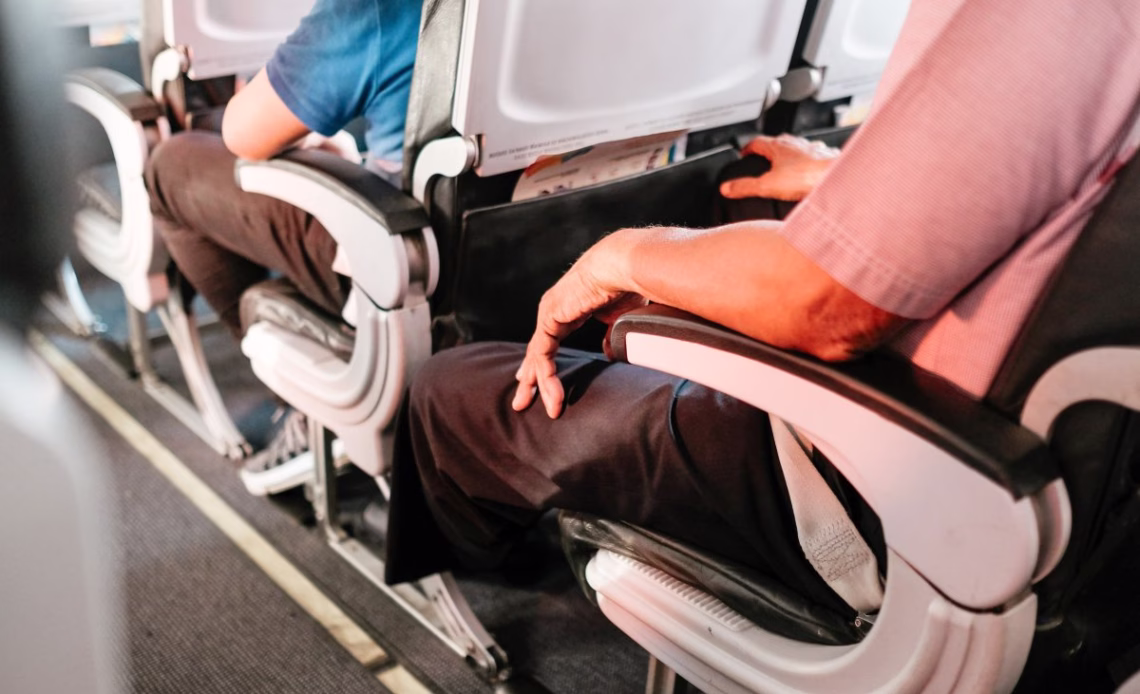 Passengers seated on a plane.