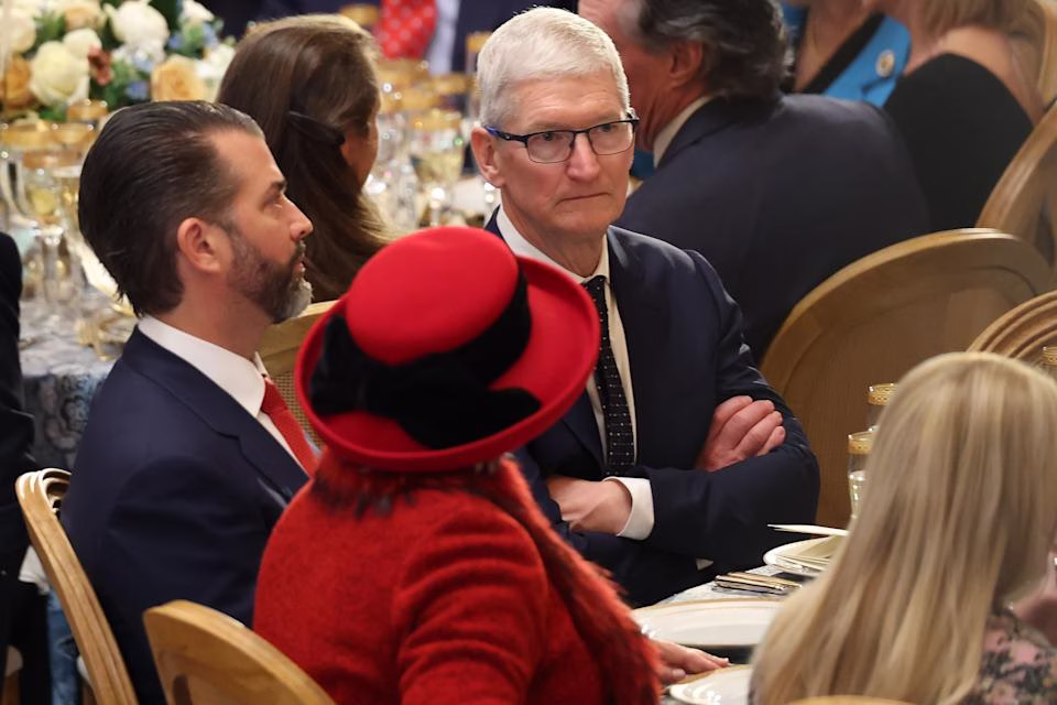 WASHINGTON, DC - JANUARY 20: Apple CEO Tim Cook (C) sits next to Donald Trump Jr at the inaugural luncheon on January 20, 2025 in Washington, DC. Donald Trump takes office for his second term as the 47th president of the United States. (Photo by Kevin Dietsch/Getty Images)