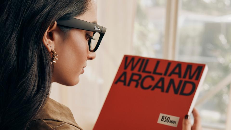 Over-the-shoulder view of a person looking at a book cover in a store while wearing the Ray-Ban Meta glasses.