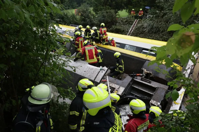 Rescue workers search for passengers in a derailed train. Several people have been killed and many others injured after a passenger train derailed in Biberach district between Zweifaltendorf and Zell in south-western Germany. Thomas Warnack/dpa