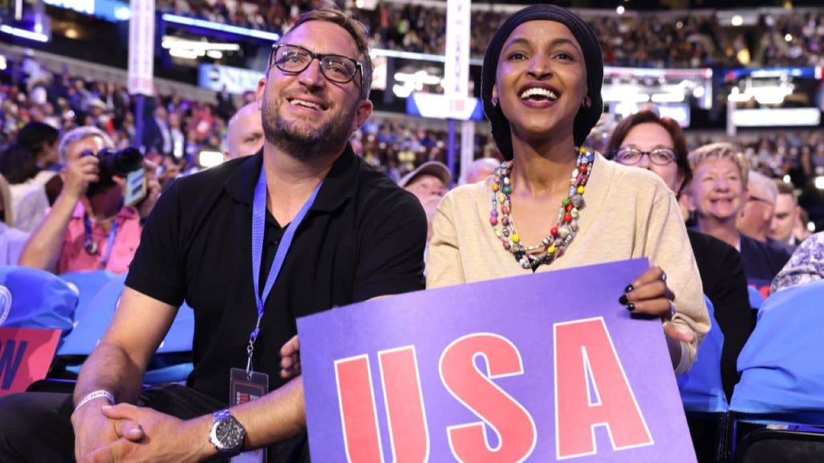 Rep. Ilhan Omar (D-MN) sits with husband Tim Mynett during the first day of the Democratic National Convention at the United Center on August 19, 2024 in Chicago, Illinois.
