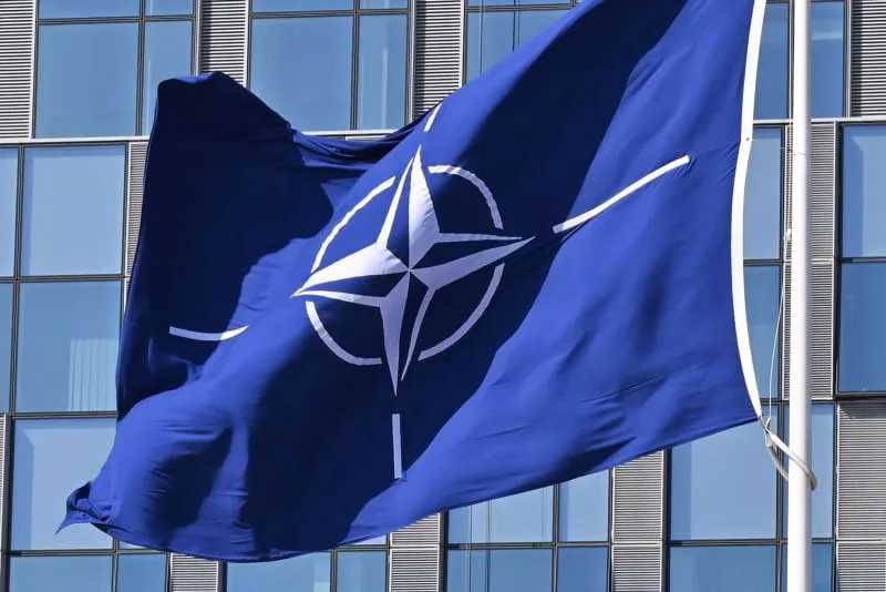 A NATO flag flies in the wind in front of the NATO headquarters in Brussels. Anna Ross/dpa